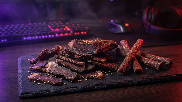 Gorgc's Favorites — South African-style biltong on slate with purple and red gaming lighting, blurred RGB keyboard and headset