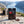 Meat Makers Beef Original Hot on a rock beside a mountain trail above a Norwegian fjord, with a backpack and thermos, AI-generated image