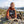 Hiker taking a break in the mountains holding Meat Makers Beef Original Smoky, AI-generated image