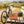 BiFi Chicken Roll 3-pack on a bench by a gravel road through vineyards, with a bike and a cycling helmet, AI-generated image