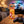 BiFi Currywurst 3-pack on a coffee table in the evening, with a game controller and a small bowl, AI-generated image
