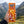Hand holding BiFi Currywurst 3-pack in front of an alpine mountain landscape, AI-generated image