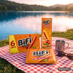BiFi Starter Pack on a checked picnic blanket by a lake on a summer day, with a steel cup and sunglasses, AI-generated image