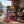 BiFi Tasty Bites Thai Hot Chili on a wooden table in a mountain chalet, with a wool blanket, an enamel mug and snowy mountains outside, AI-generated image