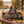 BiFi Tasty Bites Thai Hot Chili sticking out of a backpack on a park bench in autumn, with a water bottle and headphones, AI-generated image