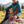 Hiker taking a break on an alpine meadow holding BiFi Tasty Bites Thai Hot Chili, AI-generated image