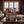 Big Brand Originals Beef Jerky Mixed Pack on a wooden table in a mountain cabin, with a wool blanket, an enamel mug and snowy mountains outside, AI-generated image