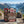 Big Brand Originals Beef Jerky Mixed Pack on a rock beside a mountain trail above a Norwegian fjord, with a backpack and thermos, AI-generated image