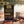 Biltong Premium Biltong Original on a checked picnic blanket by a lake on a summer day, with a steel cup and sunglasses, AI-generated image
