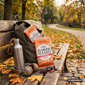 Chokay Bar Dark Almond Sea Salt sticking out of a backpack on a park bench in autumn, with a water bottle and headphones, AI-generated image