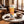 Chokay Bio Snackbar Caramel Peanut on a marble cafe table next to a cappuccino, AI-generated image