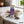 Chokay Bio Snackbar Salty Almond on a light marble kitchen counter with a linen cloth and a small ceramic bowl, AI-generated image