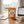 Chokay Treat Milk Peanut Rocks on a desk next to a laptop, a cup of coffee and a notebook, AI-generated image