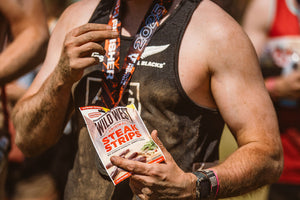 Tough Mudder competitor holding a pack of Wild West Steak Strips