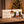 Fine Gusto Jerky Advent Calendar on a wooden table by the Christmas tree, with hot chocolate and gingerbread cookies, AI-generated image