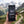 Hand holding Franky's Best Beef Jerky Classic in front of an alpine mountain landscape, AI-generated image