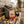 Grizzly Foods Vegan Jerky Burn Baby Burn sticking out of a backpack on a park bench in autumn, with a water bottle and headphones, AI-generated image