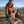 Hiker taking a break on an alpine meadow holding Grizzly Foods Vegan Jerky Burn Baby Burn, AI-generated image