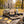 Grizzly Foods Vegan Jerky Cracked Pepper sticking out of a backpack on a park bench in autumn, with a water bottle and headphones, AI-generated image