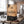 Grizzly Foods Biltong Classic on a gym bench, with dumbbells, a towel and a water bottle in the background, AI-generated image