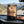 Grizzly Foods Biltong Classic on the dashboard of a car at a mountain pass viewpoint, AI-generated image