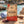 Grizzly Foods Biltong Red Heat on a rock by a Mediterranean cove, with a towel and sunglasses, AI-generated image
