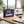 Happy Birthday Box on a desk next to a laptop, a cup of coffee and a notebook, AI-generated image