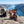 Indiana Biltong Original on a rock beside a mountain trail above a Norwegian fjord, with a backpack and thermos, AI-generated image
