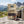 KJØ Tasty Beef Jerky on a rock beside a mountain trail in the Alps, with a backpack and thermos, AI-generated image