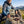 Hiker taking a break on an alpine meadow holding KJØ Tasty Beef Jerky, AI-generated image