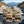 KJØ Mixed Pack on the dashboard of a car at a mountain pass viewpoint, AI-generated image