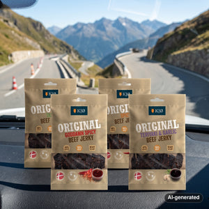 KJØ Mixed Pack on the dashboard of a car at a mountain pass viewpoint, AI-generated image