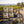 KJØ Mixed Pack on a bench by a gravel road through vineyards, with a bike and a cycling helmet, AI-generated image