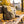 KoRo Banana Stripes sticking out of a backpack on a park bench in autumn, with a water bottle and headphones, AI-generated image
