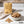 KoRo Banana Stripes on a light marble kitchen counter with a small bowl of the fruit, AI-generated image