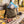 KoRo Freeze-Dried Strawberries in Milk Chocolate sticking out of a backpack on a park bench in autumn, with a water bottle and headphones, AI-generated image