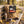 Kuivalihakundi Beef Jerky Scorpion sticking out of a backpack on a park bench in autumn, with a water bottle and headphones, AI-generated image