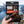 Hand holding Kuivalihakundi Beef Jerky Scorpion in front of a fjord landscape, AI-generated image