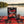 Leon Jerky Beef Original on a checked picnic blanket by a lake on a summer day, with a steel cup and sunglasses, AI-generated image