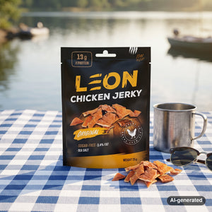 Leon Jerky Chicken Original on a checked picnic blanket by a lake on a summer day, with a steel cup and sunglasses, AI-generated image