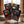 Meat Makers Snack Pack Mix on a wooden table in a mountain chalet, with a wool blanket, an enamel mug and snowy mountains outside, AI-generated image