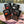 Meat Makers Snack Pack Mix on a checked picnic blanket by a lake on a summer day, with a steel cup and sunglasses, AI-generated image