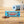 Mr. Beast Feastables Milk Crunch on a wooden floor next to a rolled yoga mat and a water bottle, AI-generated image
