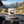 QINA Blesbok Snapstick Biltong on the dashboard of a car at a mountain pass viewpoint, AI-generated image