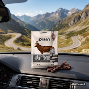 QINA Blesbok Snapstick Biltong on the dashboard of a car at a mountain pass viewpoint, AI-generated image
