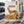 QINA Springbok Sliced Biltong on a gym bench, with dumbbells, a towel and a water bottle in the background, AI-generated image