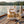 QINA Springbok Sliced Biltong on the deck of a small sailboat on a lake in the evening sun, with a rope and thermos, AI-generated image