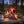 Renjer Red Deer Jerky Chili & Lime on a log by a campfire in a pine forest at dusk, with an enamel mug and a wooden cup, AI-generated image